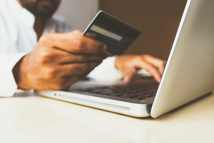 Man entering credit card details to shop online